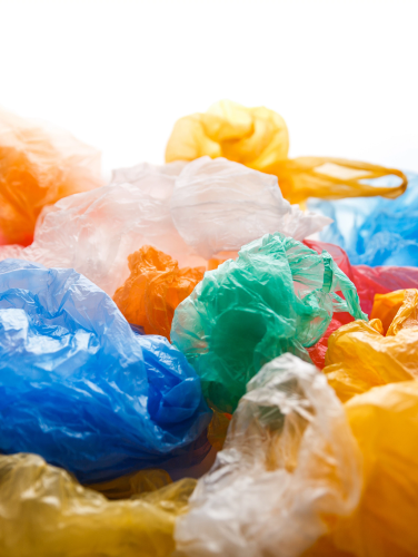 Colorful used plastic bags backlit pattern. Environmental pollution problem concept.