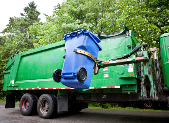 Recycling truck picking up bin Recycling truck picking up bin